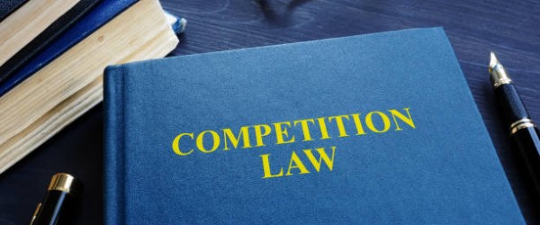 Competition law and pen on a table.