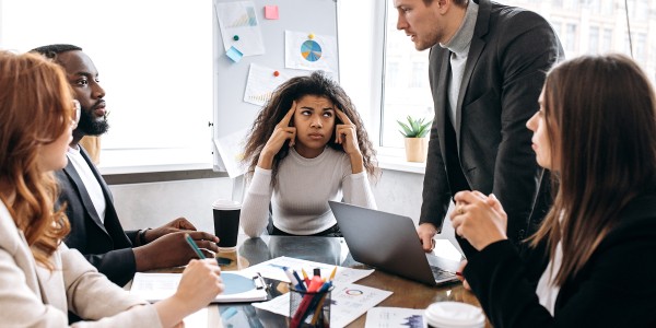 Exhausted multiethnic coworkers argue at the conference, having a tense brainstorm. Tired business team having work troubles, can't make an agreement, unsuccess and overwork concept